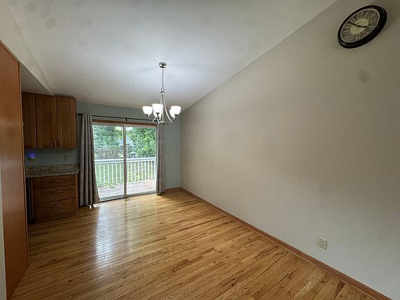 Dining room with vaulted ceiling and patio door