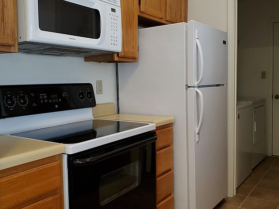 Kitchen includes cooktop stove, microwave, fridge, dishwasher and garbage disposal.