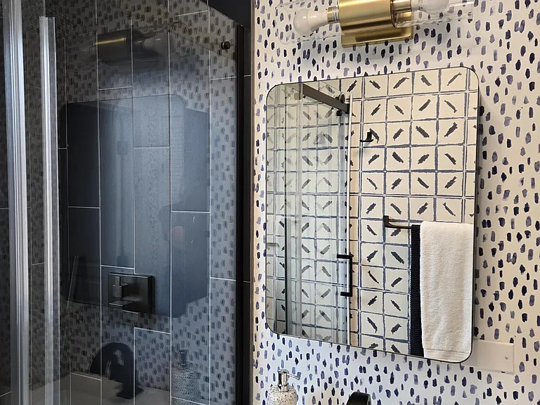 Large rain head and hand held wand. Wall to wall shower doors.
Large medicine cabinet for storage.
