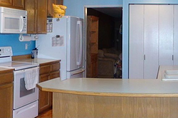 Bright Kitchen with Ample Counter Space & Cabinets