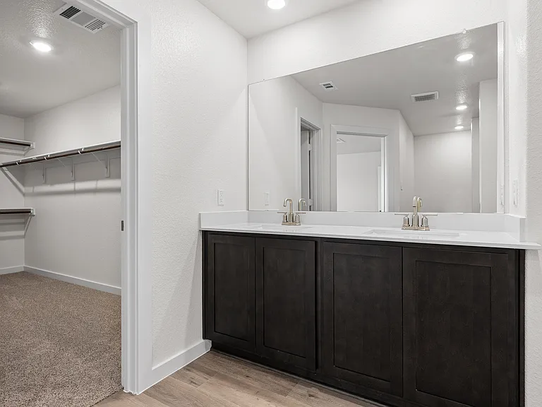 The master bathroom has a sprawling dual-sink vanity.
