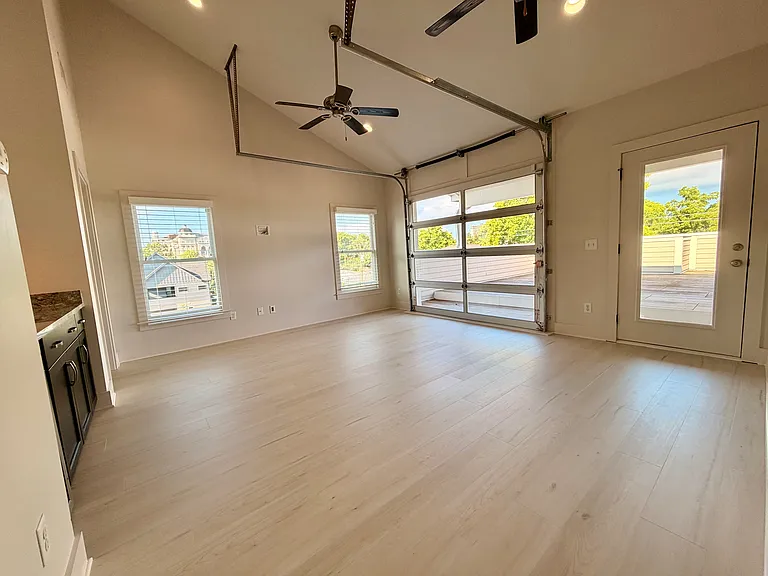 Second living room area on the third level, with an insulated garage door, that leads to the open air deck