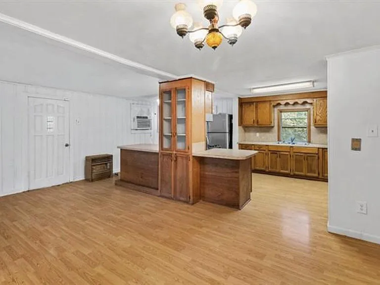 Front room, formal dining, and Kitchen view.
Suggestion: Island/bar area will seat approx. 5 barstools. You could probably fit at least 2-3 more (depending on how you set up your furniture).