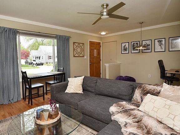 Great Room with bright picture window and ceiling fan