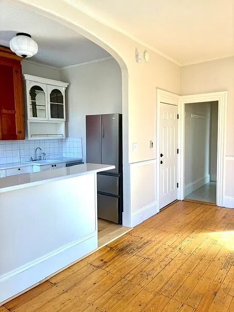 Apartment entry door with mudroom left, living room and kitchen right