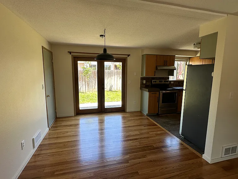 Dining area with black finish warehouse style light, french door access to back yard.