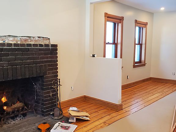 Wood mantel soon to be installed on fireplace.