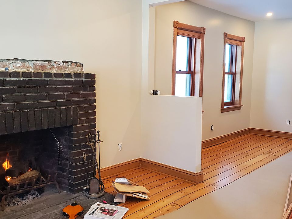 Wood mantel soon to be installed on fireplace.