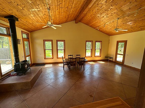 __ Warm & Spacious Living Room
Featuring vaulted cedar ceilings, open beams, and polished concrete floors, this sunlit space offers rustic charm with modern touches.