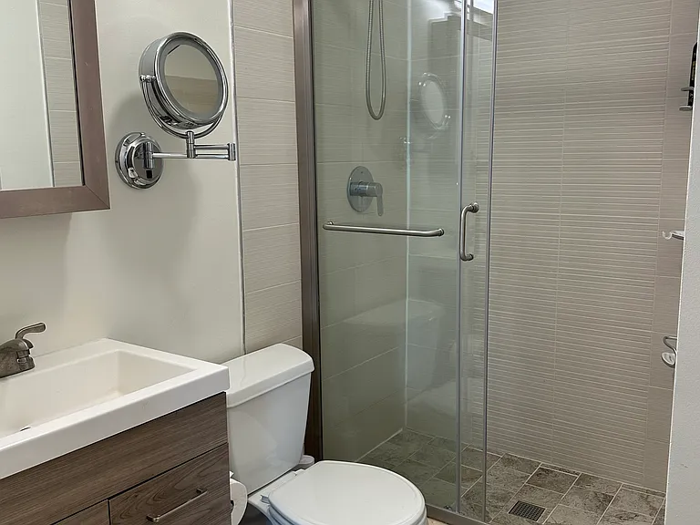 Modern bathroom within large primary bedroom