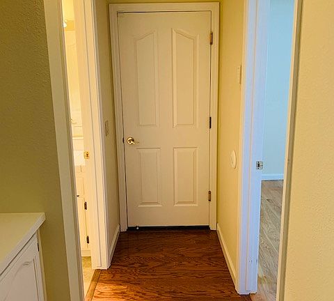 Around the corner from the entry. Door goes into the 3 car garage. Bedroom on right, bath on left.