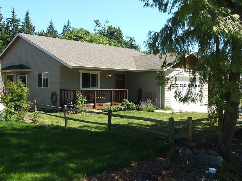Front yard with porch and glimpse of bay window off dining room...