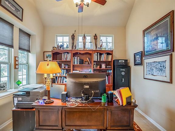Natural light streams into the study with lighting from two sides as well as a nice tiled floor and neutral paint tones.