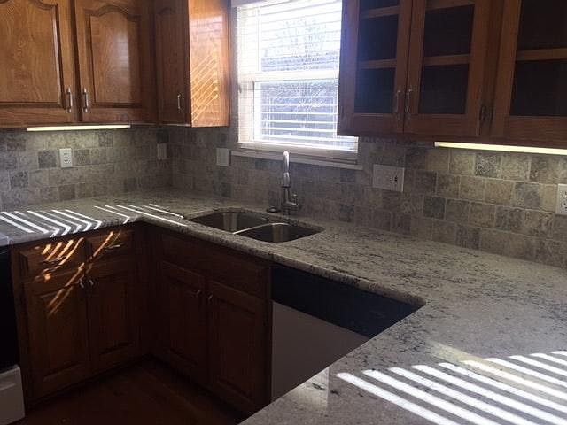 Granite top kitchen with tile back splash and undermount sin