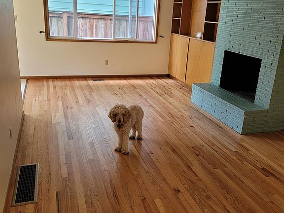 Large living room with built-ins and hardwood floors