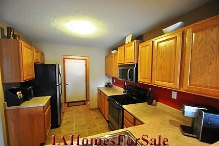Kitchen, appliances included! Open plan w/ plenty of cabinets & counter space...not in pic is a large coat-closet w/ additional room for storage!