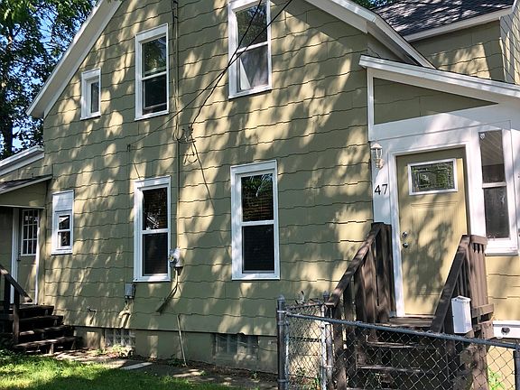 Side view of home, deck of kitchen and fenced in yard