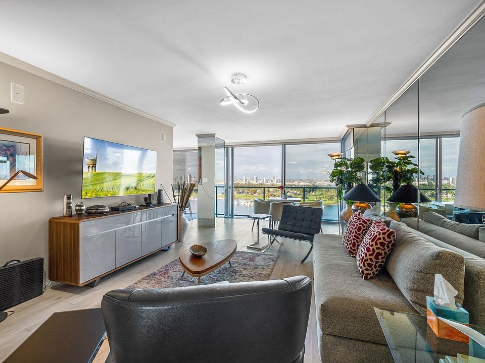Living room with panoramic bay views, Coronado Bridge and Downtown San Diego.