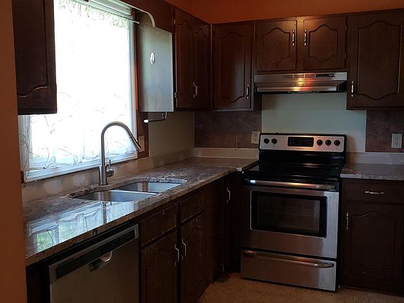 kitchen is now painted gray like the rest of the house with tile floors