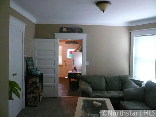 Cozy living room leading into master bedroom