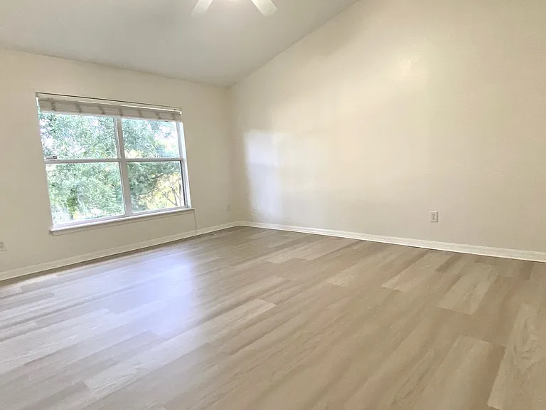 Large Master bedroom with big window over looking back yard