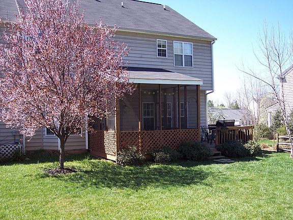 Spacious backyard with screened porch and gilling area.