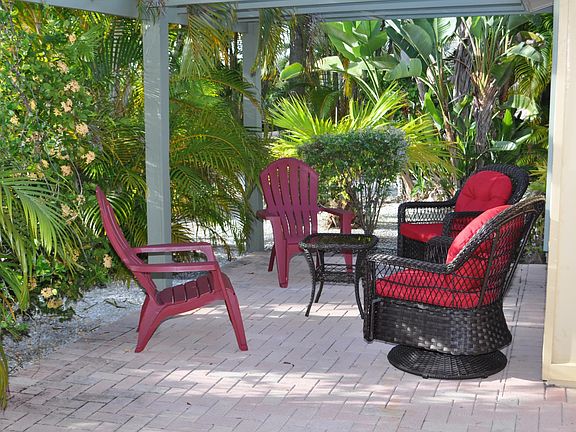 Evening cocktails on the patio are a favorites. Vegetation creates secluded environment.
