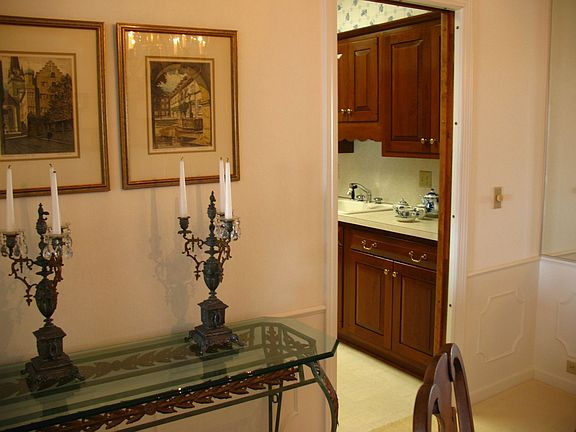 A corner of the Formal Dinning room leading to the Kitchen w/Cherry Wd. Cab.