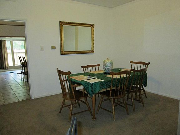Large dining area adjacent to the living area . Powder room is to the left.
