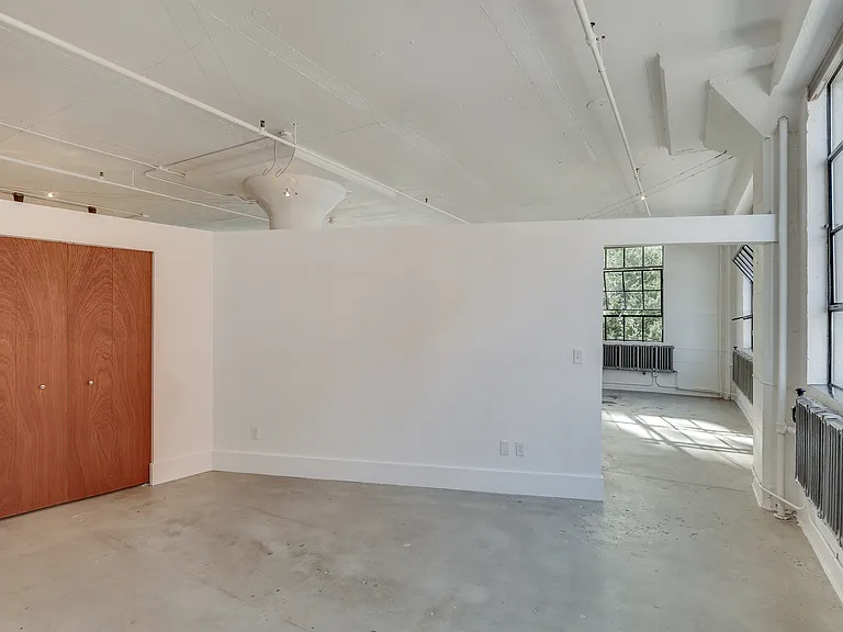 Primary Bedroom with closet looking back into living area