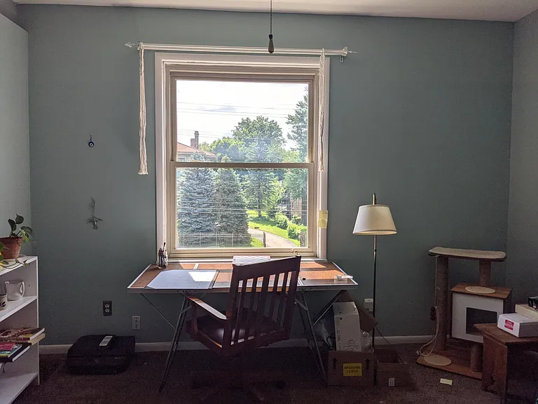 Bedroom #3 on second floor with large street view window. Currently being used as an office.