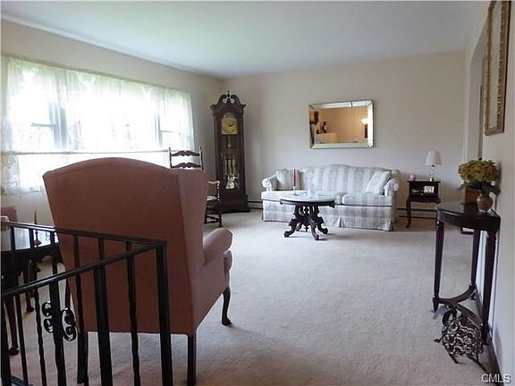 Sunny living room with real hardwood floors under the wall-to-wall carpet