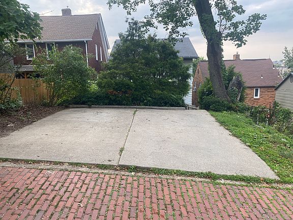 LEVEL parking pad in alley behind the house for 2 vehicles