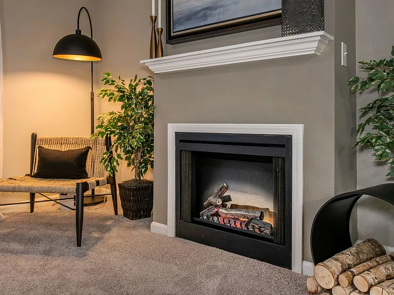 Delight in the warmth of a fireplace, adding a modern, cozy elegance to living spaces (in select homes).