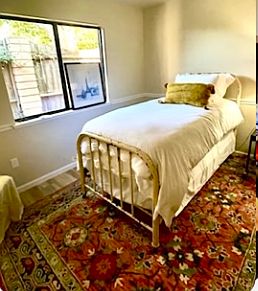 Larger of two downstairs bedrooms. Mirrored closet doors. Spacious, with a chair rail.