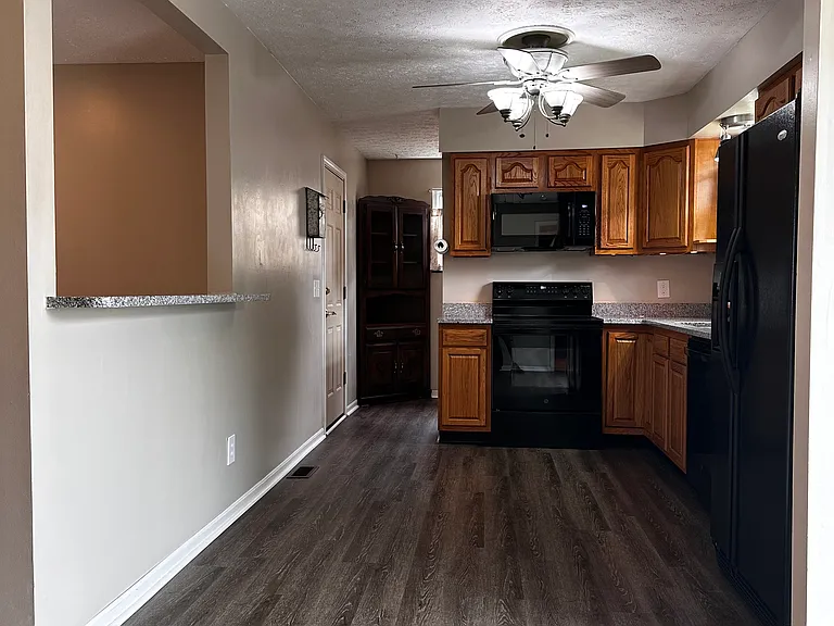 Vinyl flooring in dining, kitchen, and utility area.