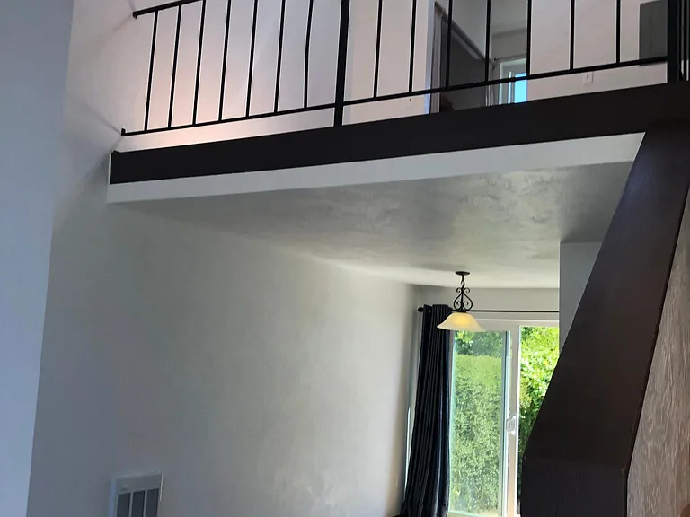 Living space with loft bedroom above