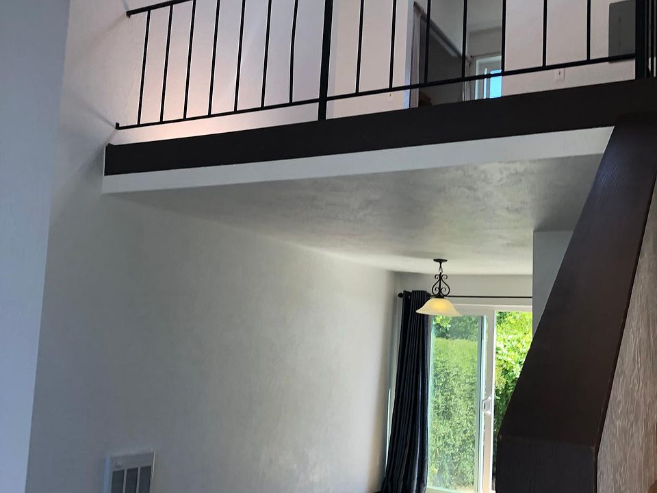 Living space with loft bedroom above