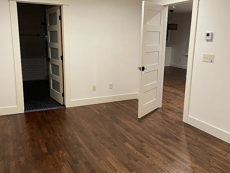 Primary suite view back to door and bath