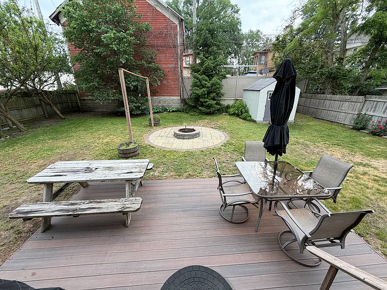 Fenced in backyard with fire pit