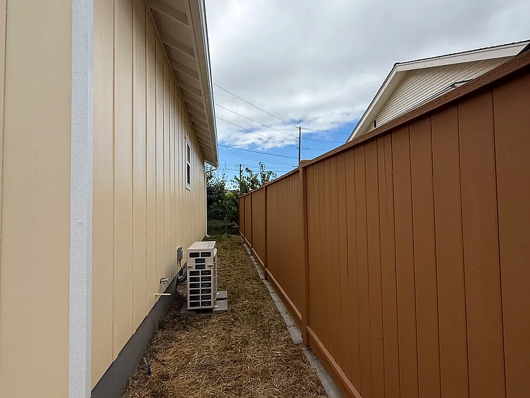 Fully fenced with ductless exterior unit. Easy-care yard