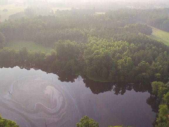 Aerial looking at the property from the backside of the lake showing approx 674 feet of water frontage