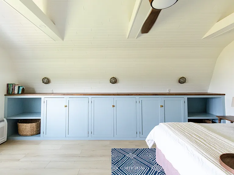 The master room includes a king size bed, built-in closet space, a dresser, a desk, and a smart TV