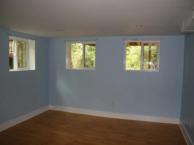 Large downstairs bedroom with 4 windows and a large closet. Furnished for a movie-watching area (a couch and a loveseat) and a double bed. Photos with furniture coming soon.