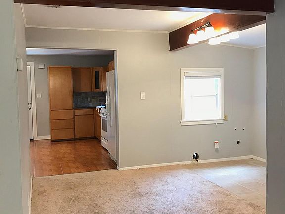 looking back towards kitchen, front door behind