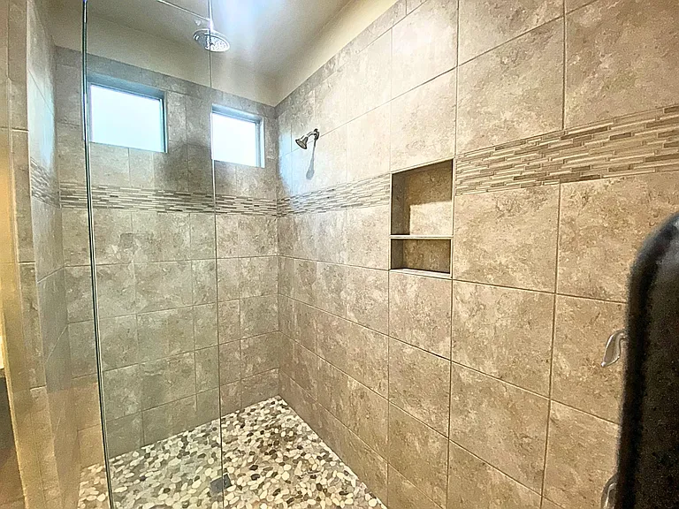 Primary Walk-in shower with dual shower heads.