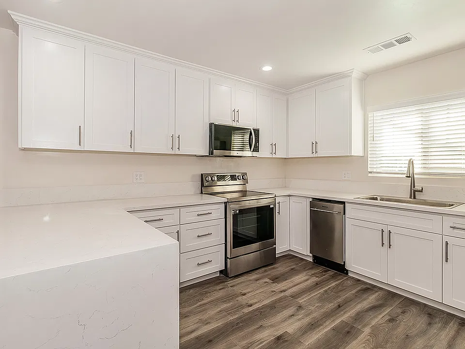 Updated Kitchen with Quartz Counter tops, high end appliances, LVP flooring, custom cabinets to the ceiling with soft close cabinets.