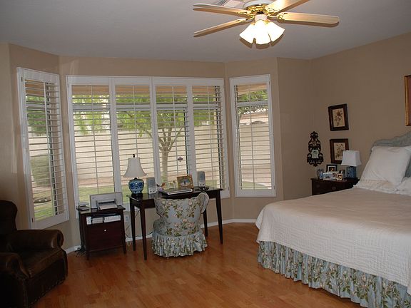 Master bedroom with bay window and wood floors.