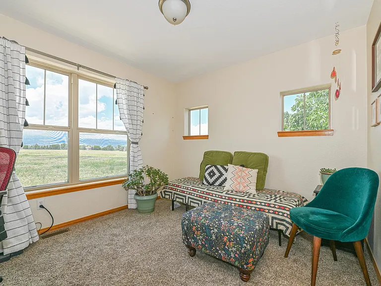 Upper guest bedroom with mountain views and private bath next to it