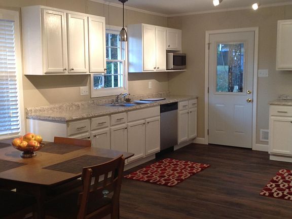 Total renovated kitchen with new appliances. Eat in kitchen and door to carport.